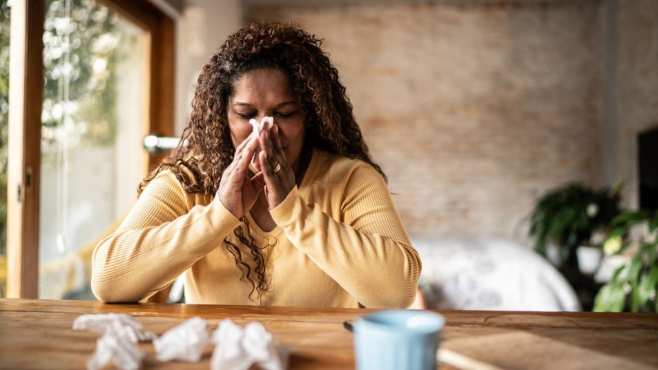 sick woman with tissues