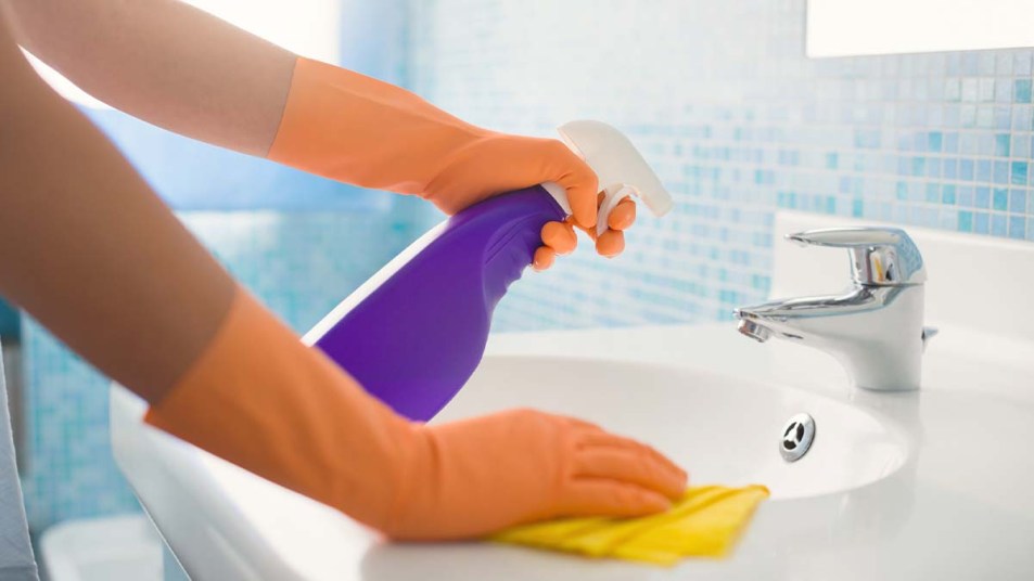 Woman cleaning bathroom