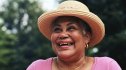 senior woman wearing straw hat smiling, feel happier concept