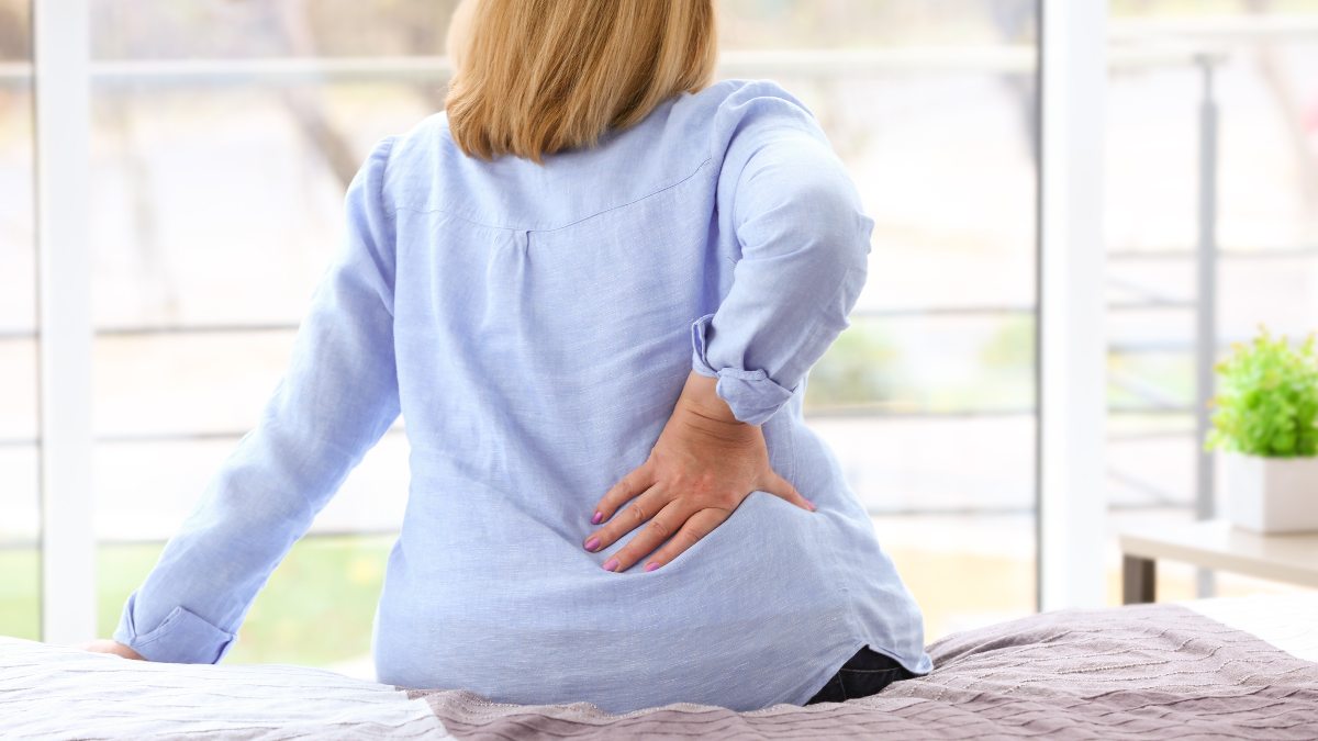 https://www.womansworld.com/wp-content/uploads/2023/05/Senior-woman-with-back-pain-sitting-on-bed.jpg