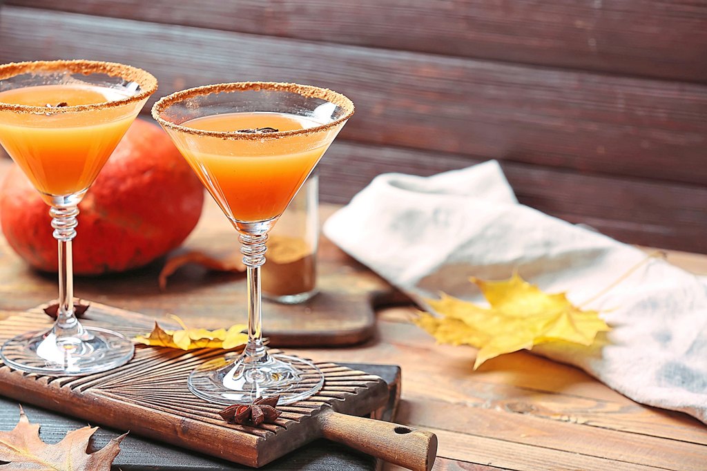 Glasses of tasty pumpkin pie martini on table