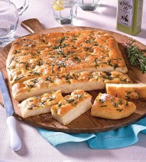 rosemary focaccia bread recipe: loaf cut on serving board