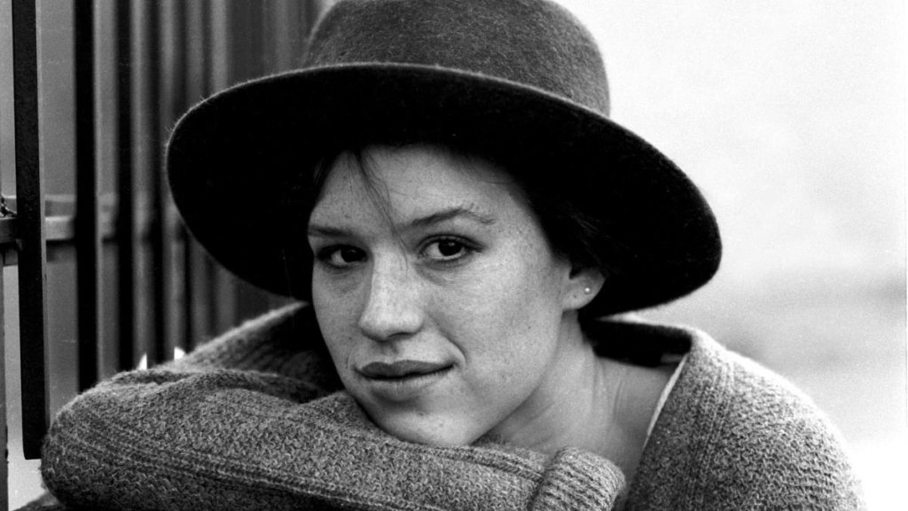 Girl with hat smiling; Molly ringwald