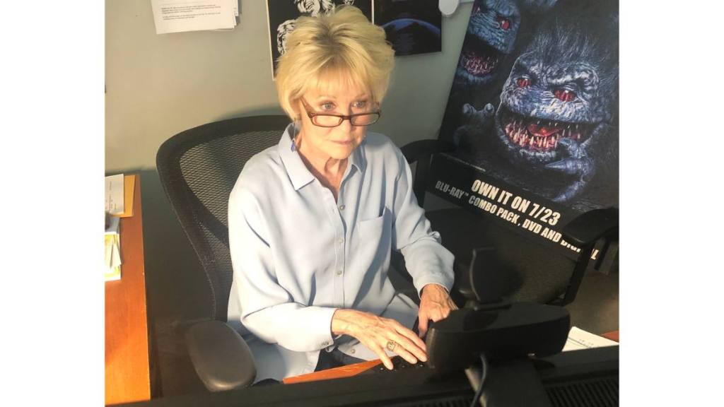 woman working on computer; dee wallace