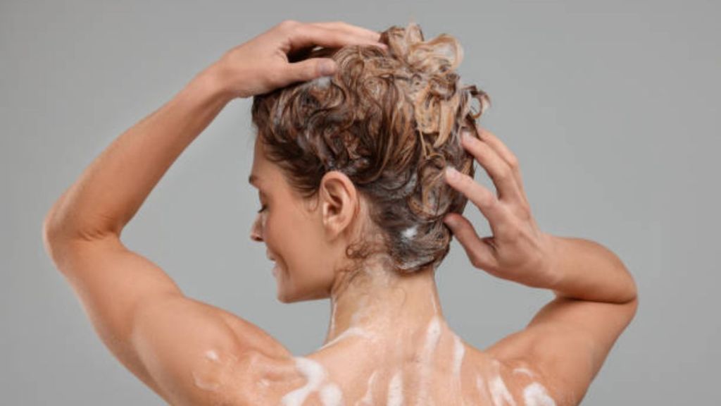 mature woman using ketoconazole shampoo to prevent dandruff and hair loss