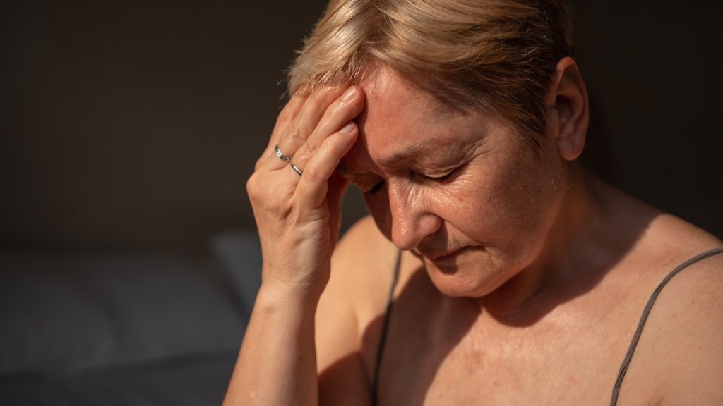 Older woman experiencing headache