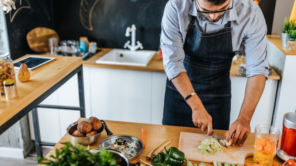 Man cutting vegetable in kitchen