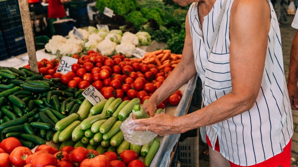An older woman shops at a farmer's market