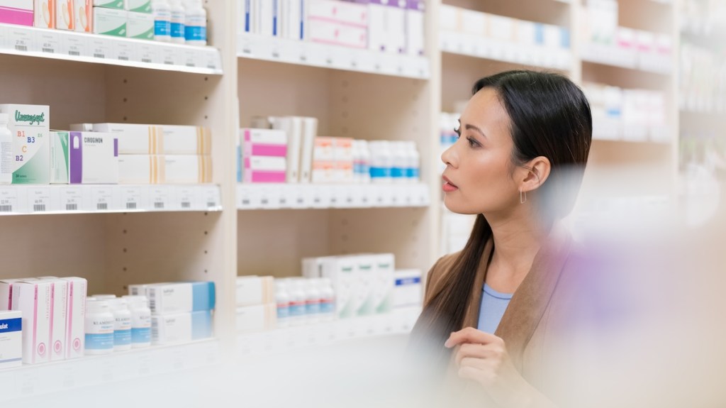 A woman browses pharmacy shelves