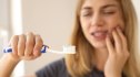 Woman with teeth pain as she's brushing