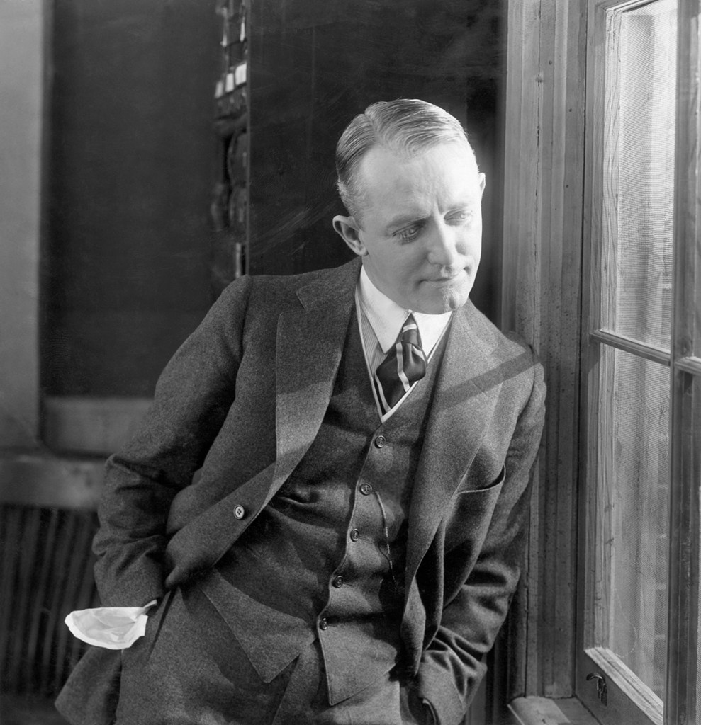 Photograph of George M. Cohan (1878-1942) American actor and playwright and also producer, leaning against window