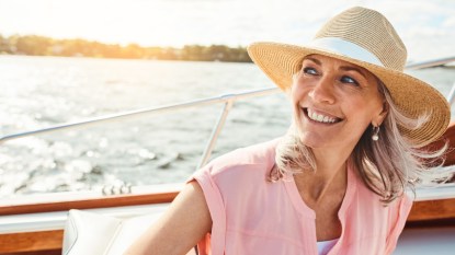 mature woman wearing sun hat on boat