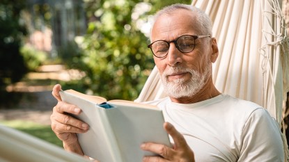 man reading a book outdoors; father's day books