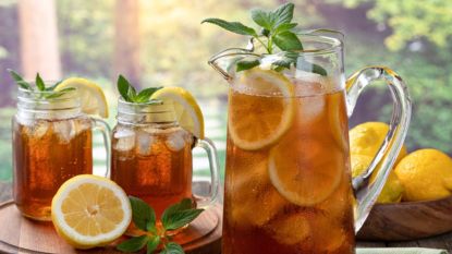 pitcher and glasses of sun tea outside with lemon slices