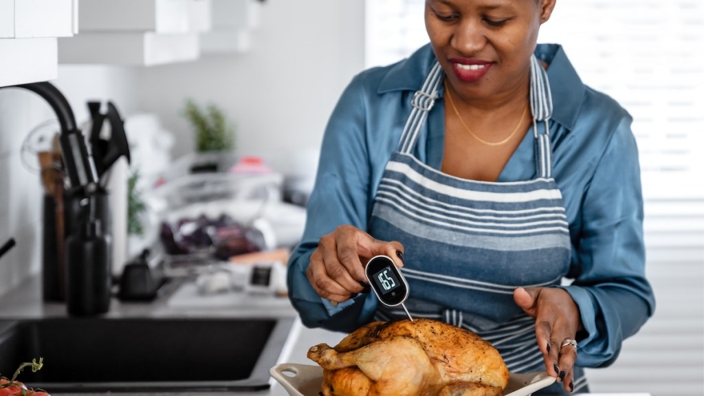 Woman making chicken in her kitchen