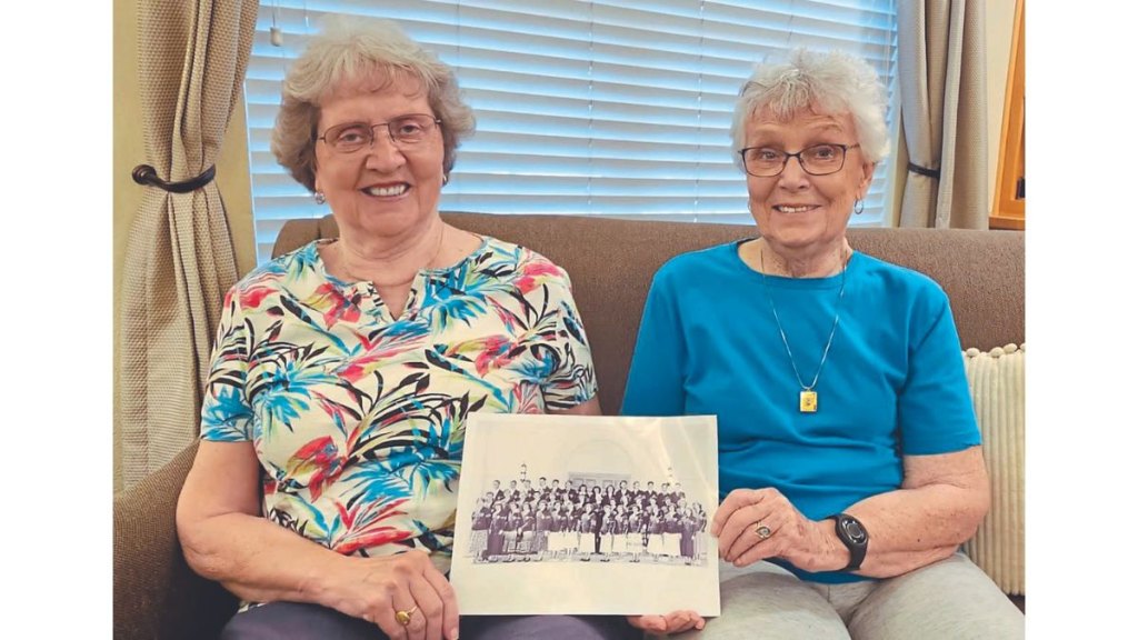 Friends holding school photo