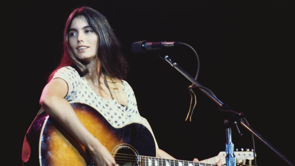 woman playing guitar; emmylou harris greatest hits