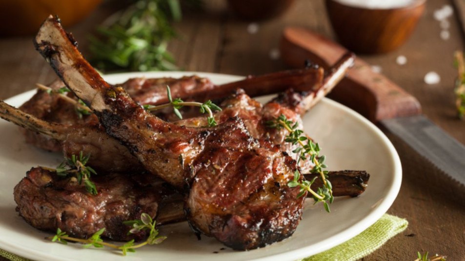 plate of pan-seared lamb chops with herbs