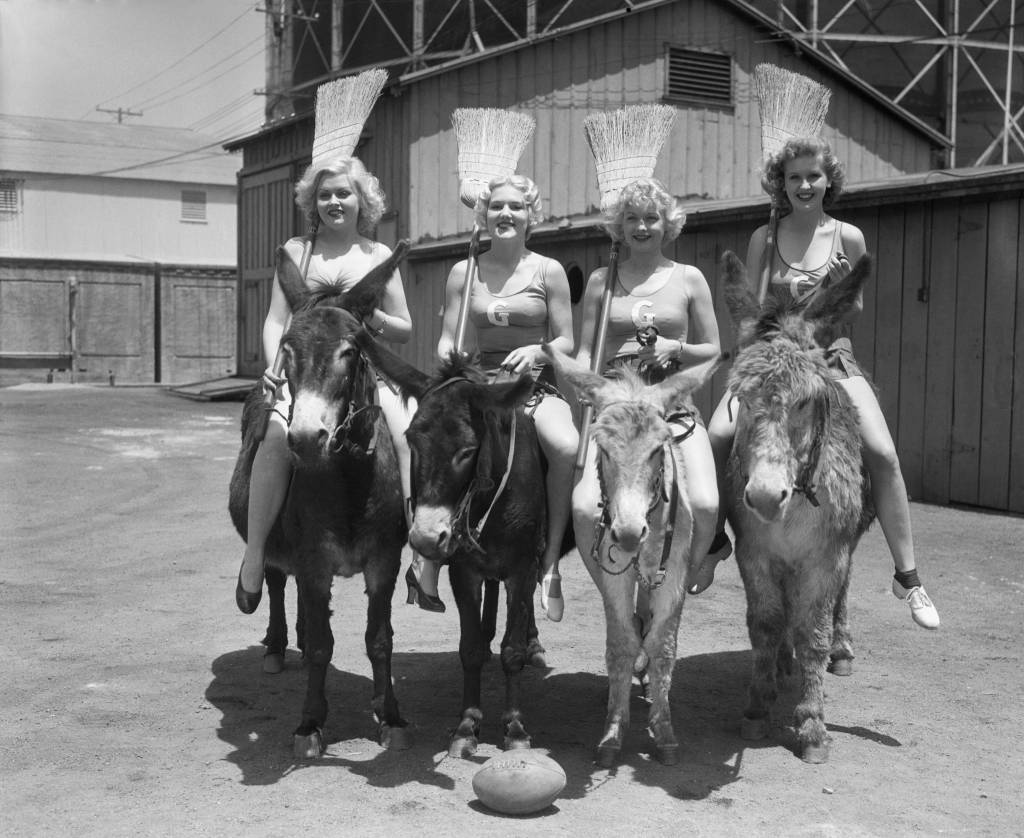 A huge outdoor gathering of screen and stage celebrities attended the Screen Stars' Polo Game at the Uplifters' Field. The main event was the producers against the actors. Before the regular match, a very funny event took place: girls on donkeys playing polo with brooms as mallots and a football as the ball. Left to right of the winning team: Barbara Peeper, Vivian Keefer, Lucille Ball and Jane Hamilton. This team was sponsored by Eddie Cantor.