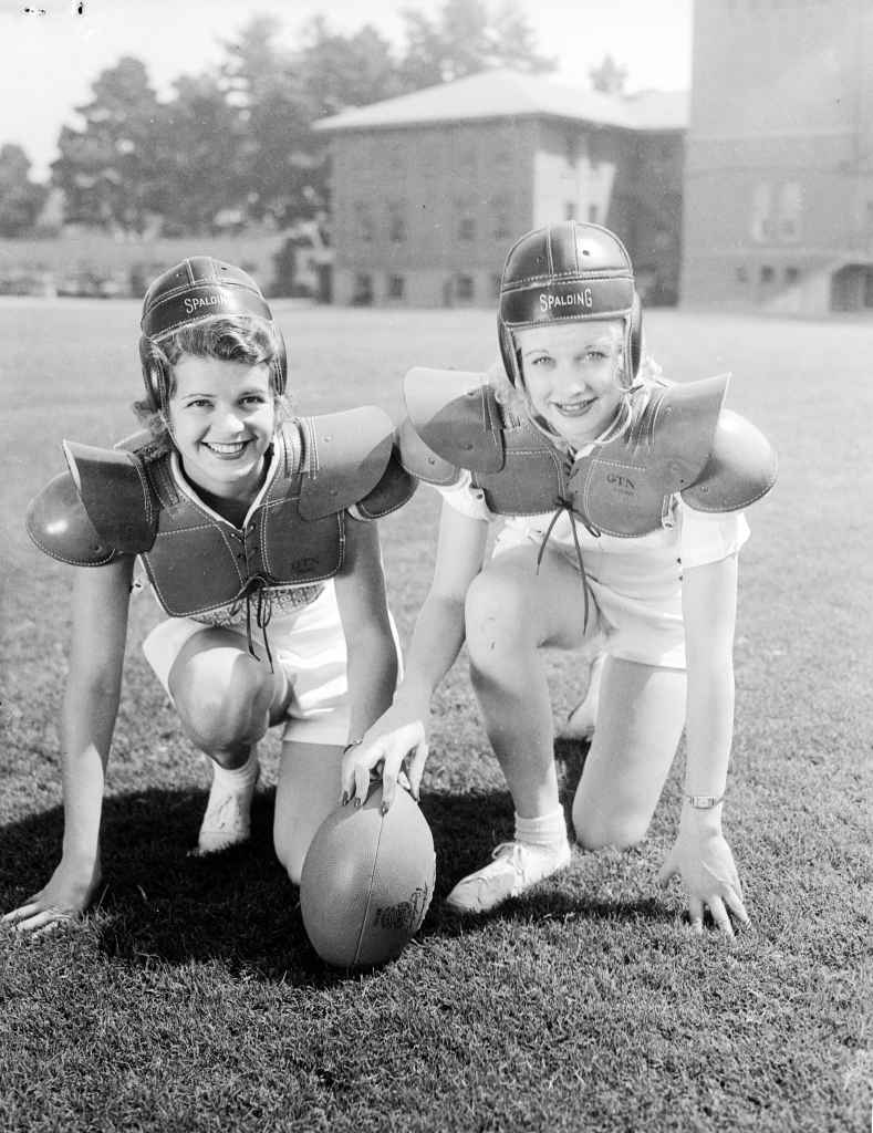 (Original Caption) The annual Fall Football hysteria is with us again, but girls like Billie Seward, (L), and Lucille Ball, film players, make it more bearable and decorative by posing in grid toss. They're seen here at Bovard Field in Los Angeles.