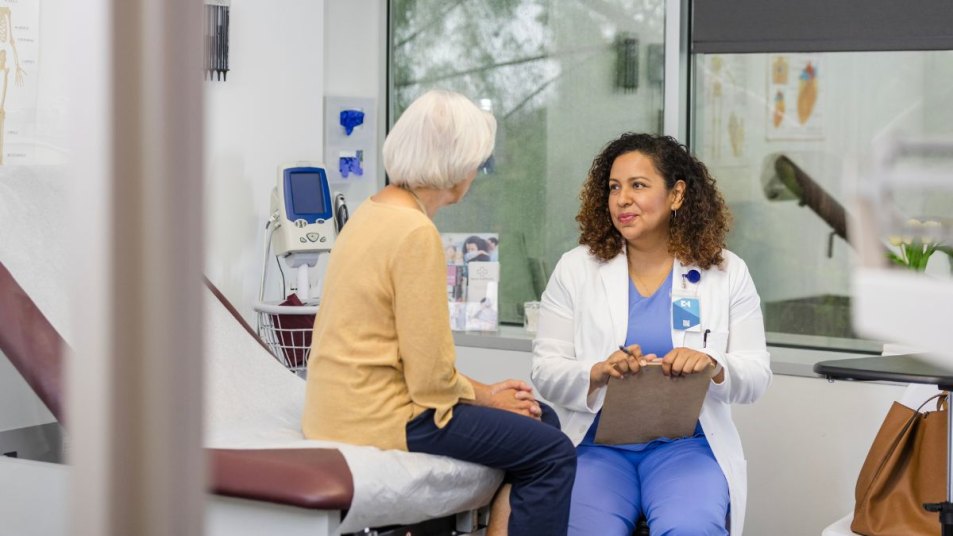 doctor listening to female patient