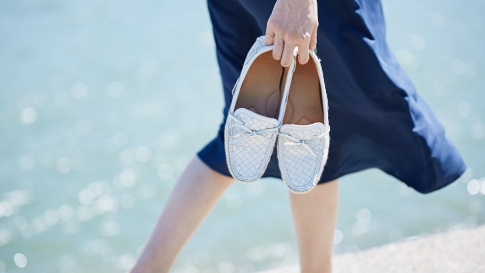 woman holding boat shoes