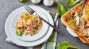 A square dish of chicken pot pie topped with puff pastry