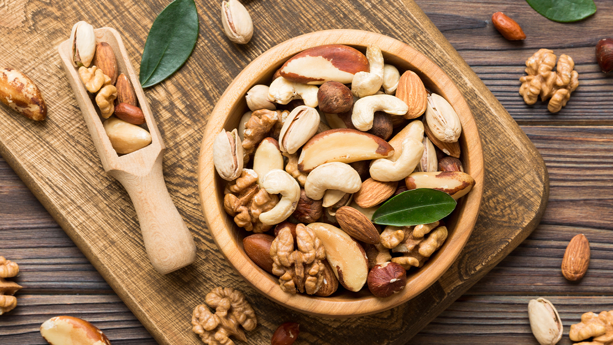 bowl of mixed nuts on a wooden board
