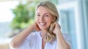 Woman smiling and touching her hair