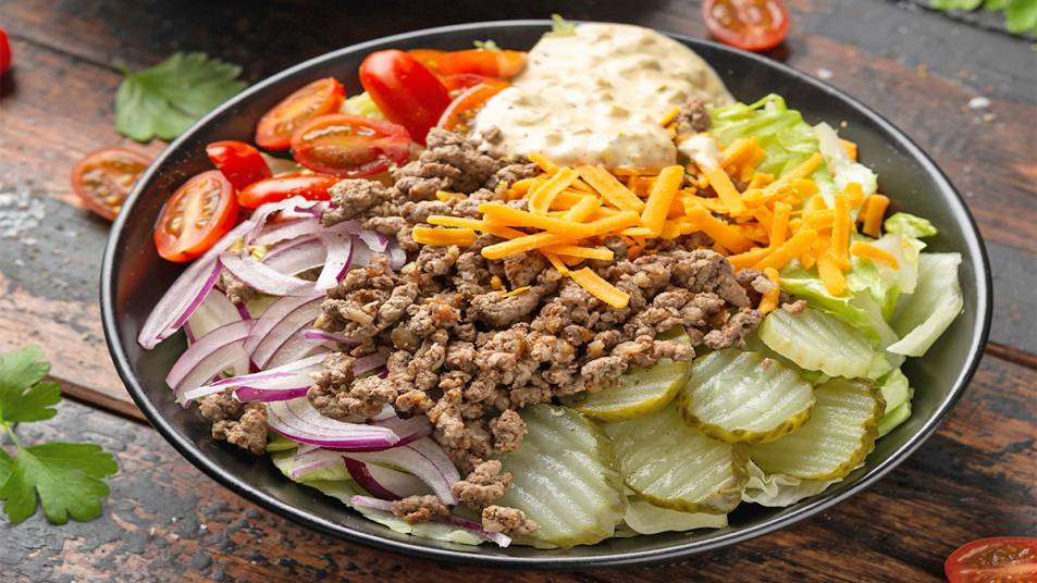 Burger bowl with various ingredients and condiments