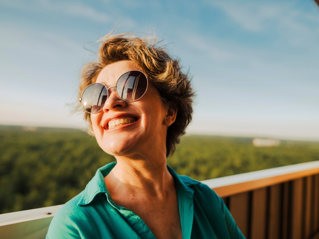 mature woman wearing sunglasses outside