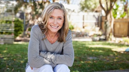 mature woman outside in the sun smiling