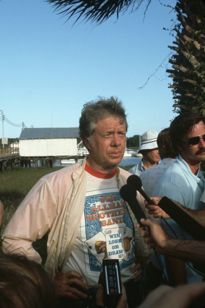 Georgia governor and US presidential candidate Jimmy Carter, dressed in an Allman Brothers T-shirt, talks with the press while vacationing on Jekyll Island, just after the 1976 Democratic convention