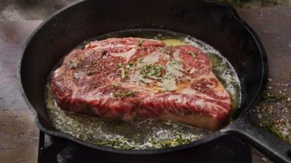 reverse seared-steak in cast iron pan with butter and thyme