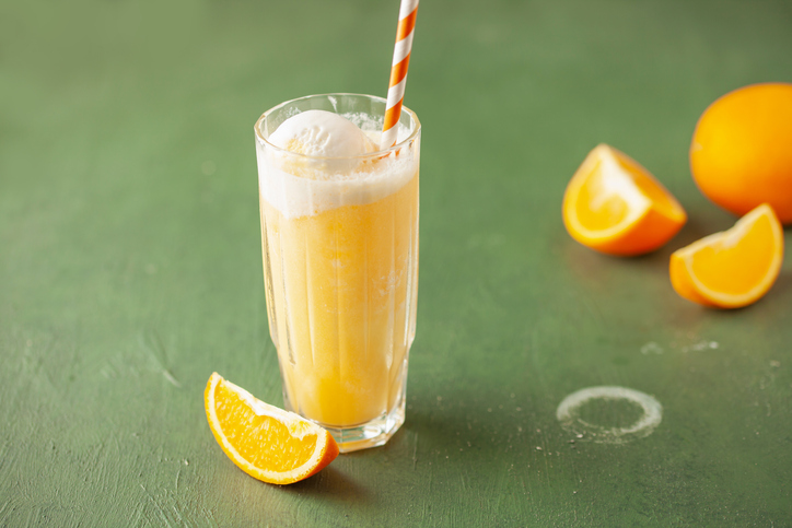 Orange creamsicle drink in glass with oranges