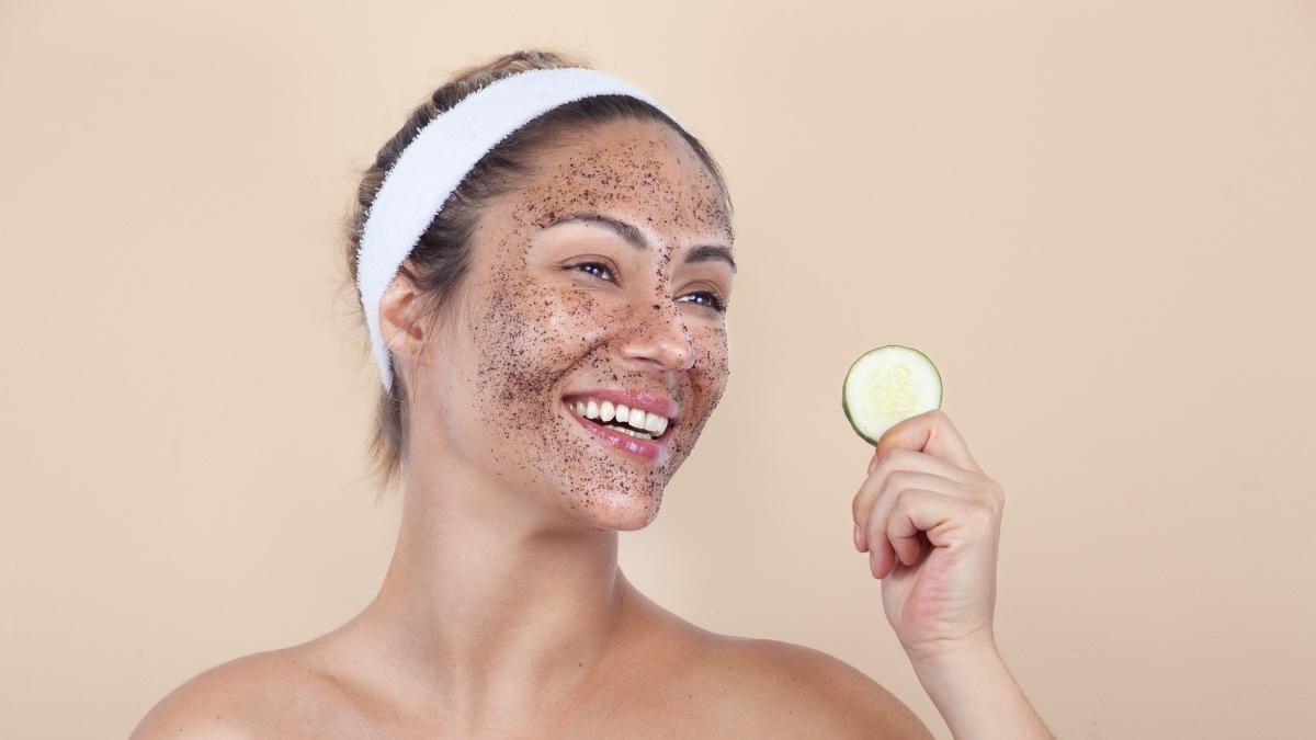 A woman in a coffee scrub mask to brighten dull skin