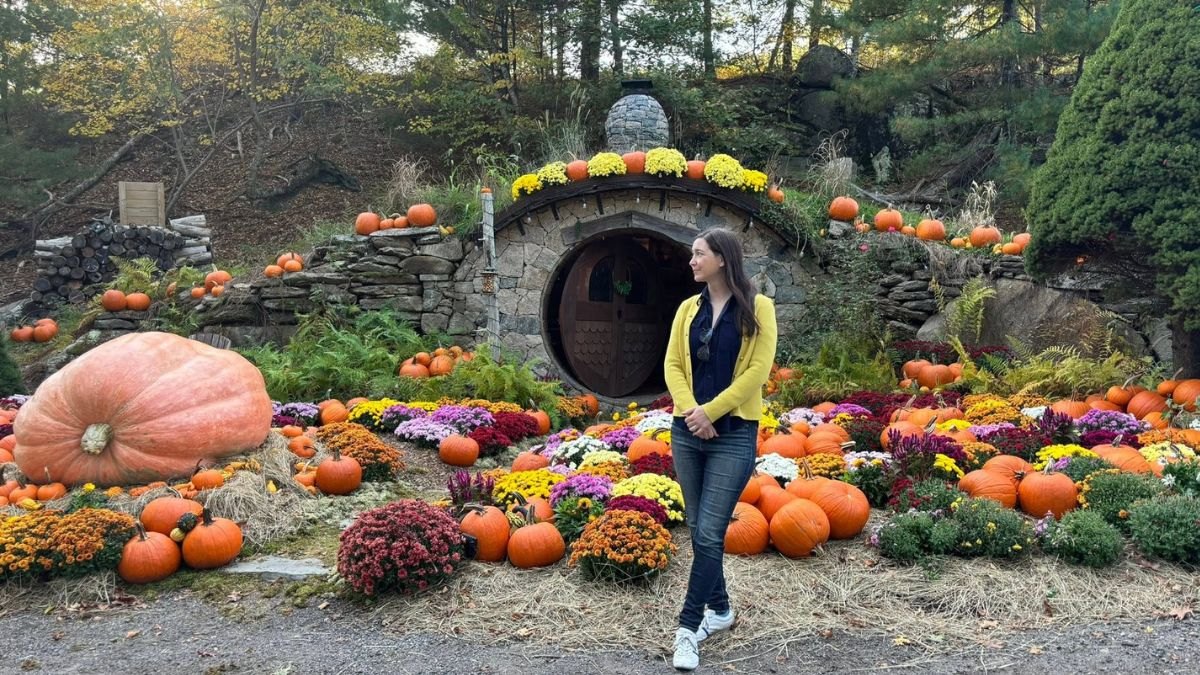 A woman poses in front of the Hobbit House at The Preserve Resort in Rhode Island
