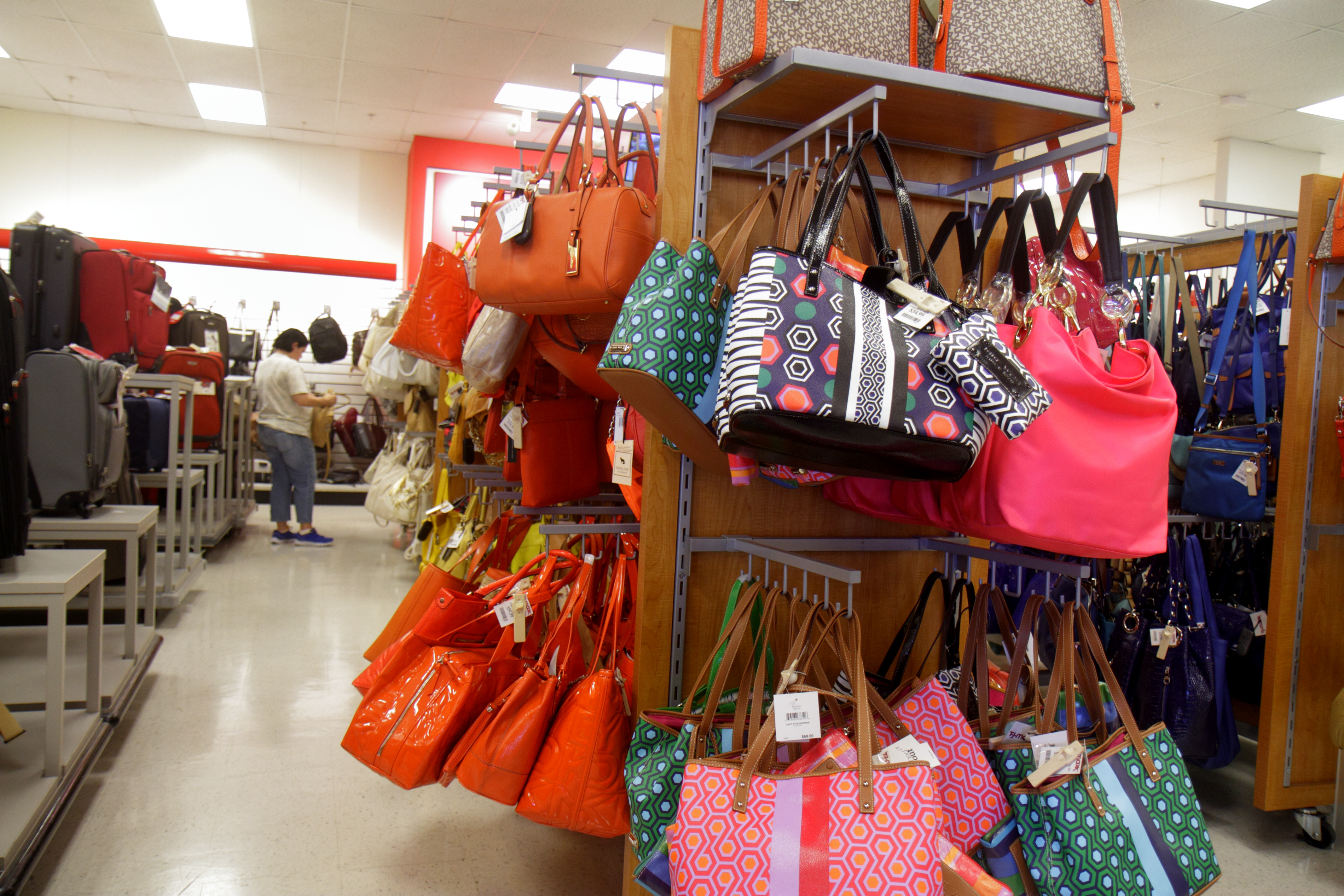 Shoppers sit with bags of merchandise outside a TJ Maxx store in News  Photo - Getty Images